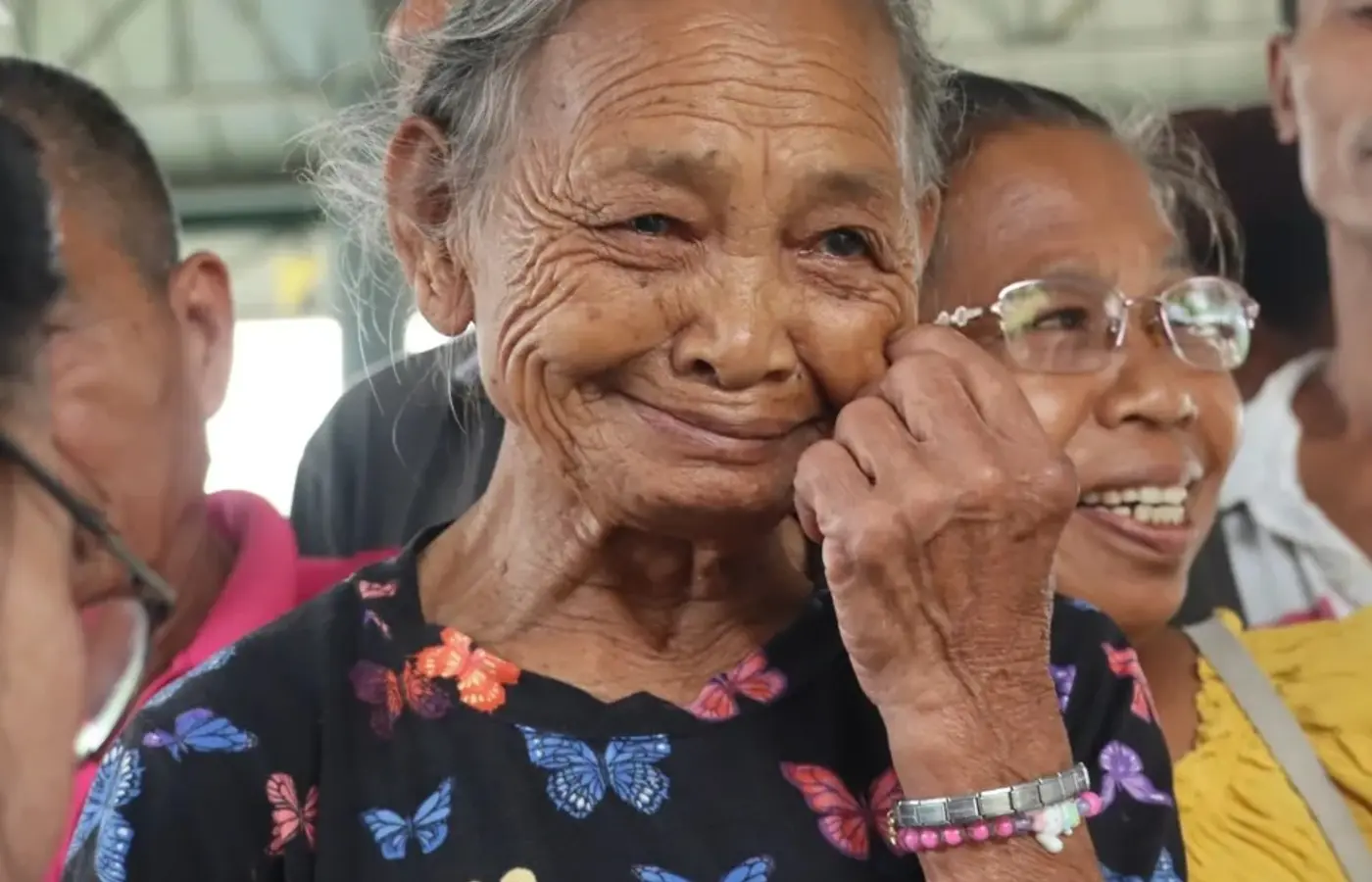 Elderly woman smiling warmly at a WSRC community event in Mindanao